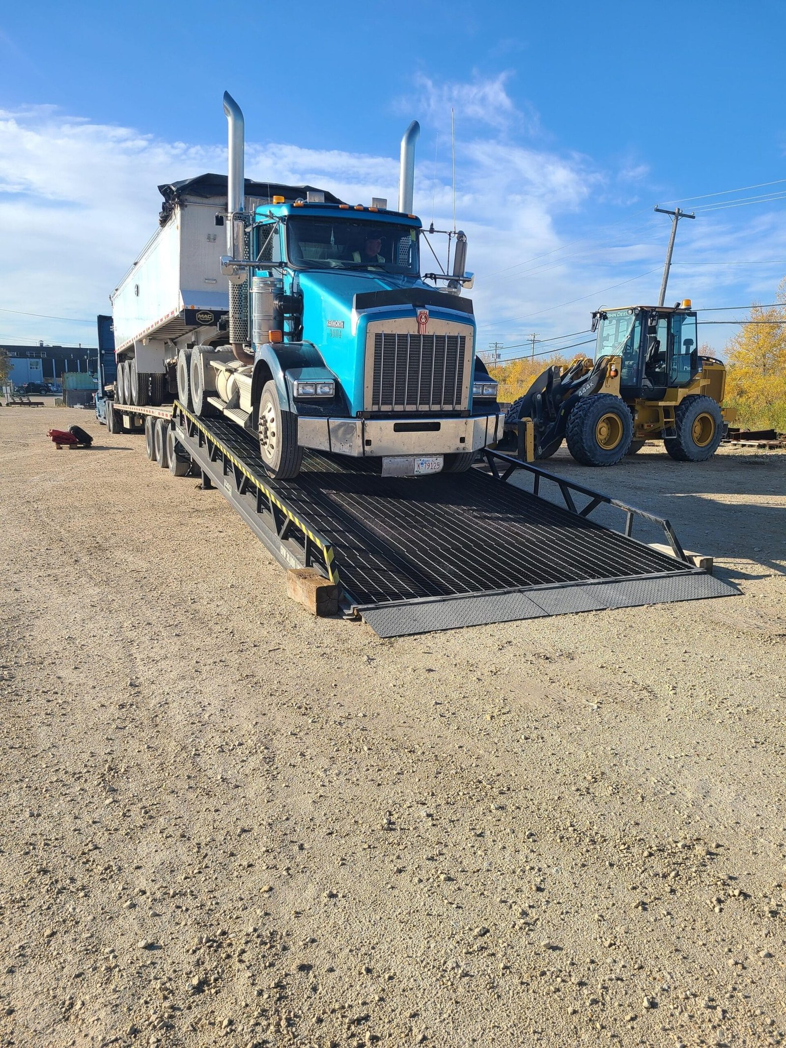 Equipment Loading Ramp uloading a semi truck